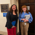 Baylee and a staffer from Rep. Evan's office stand smiling for a photo at the office door.