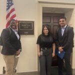 Axl and Aaron stand outside of Rep. Torres' office with a congressional staffer.