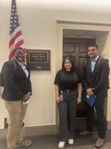 Axl and Aaron stand outside of Rep. Torres' office with a congressional staffer.